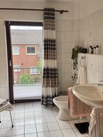 Galeriebild 7: Badezimmer mit Wanne, zwei Waschbecken und Zugang zum Balkon